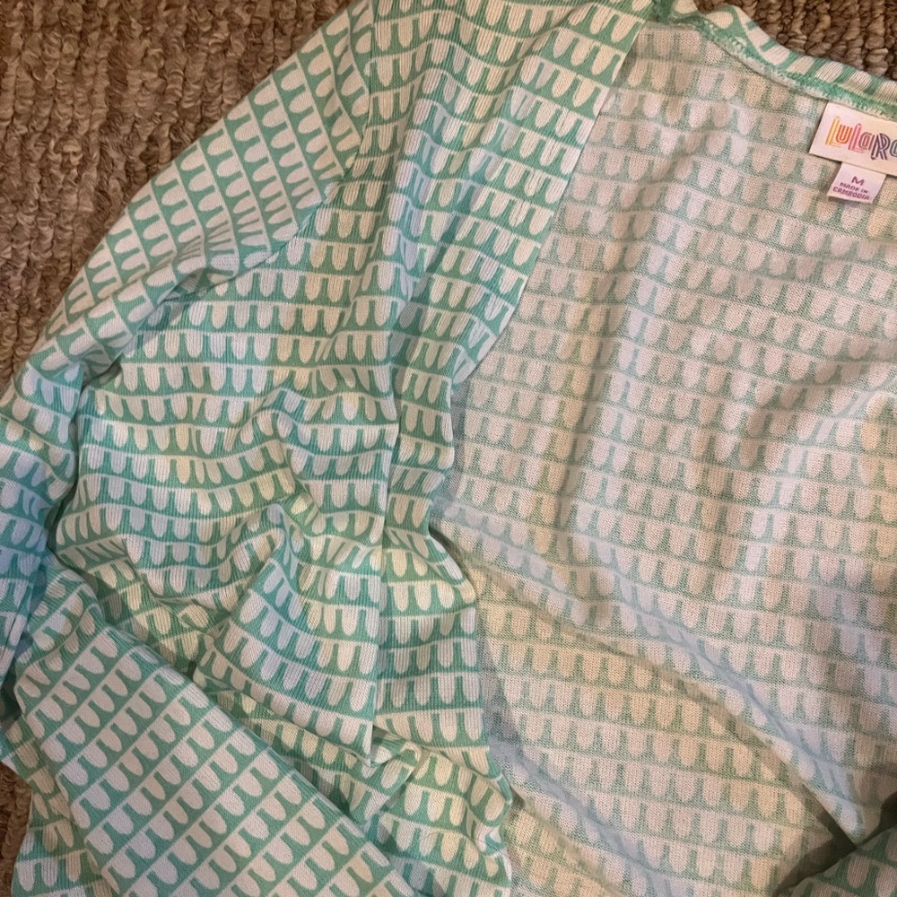 Green and white cardigan.